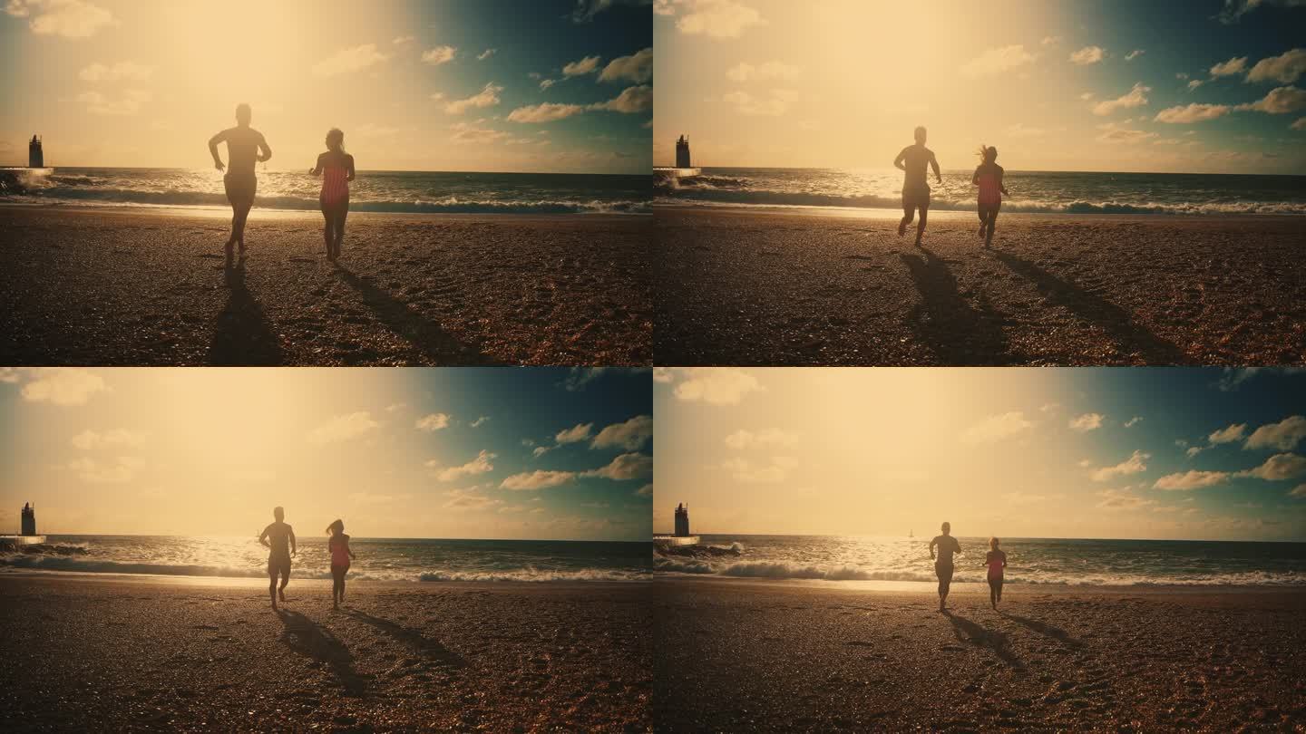 一对无忧无虑的情侣在沙滩上奔向阳光明媚、宁静的大海。无忧无虑的夫妇在沙滩上奔向阳光宁静的海洋，享受夏