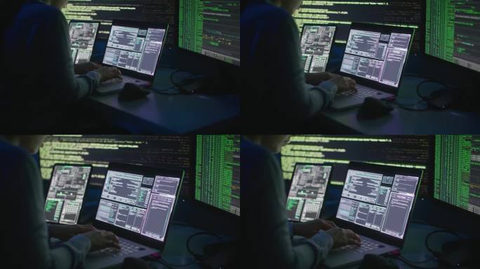 黑客或网络犯罪分子在晚上坐在电脑前窃取网上信息