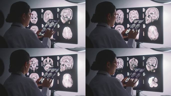 女医生正在用计算机分析屏幕上的x射线