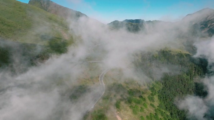 电影式的无人机在山间弯曲的乡村公路上飞行