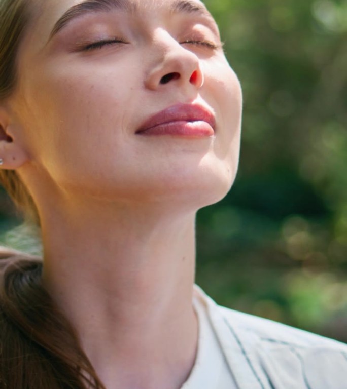 肖像梦幻般的美女站在绿色的森林里。温柔少女垂直