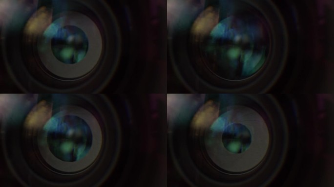 电影镜头的虹膜打开和关闭的微距镜头。窗式反射在镜片上，不同的镜片涂层可见。
