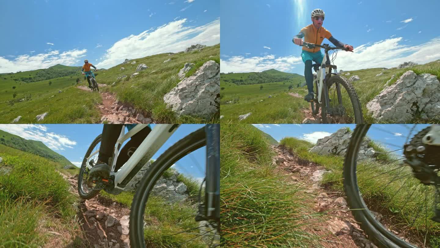 SLO MO男性山地自行车手在阳光下沿着岩石小道下山