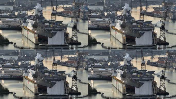日出时停泊在海军造船厂干船坞的军舰。美国海军舰艇维修的航拍照片。
