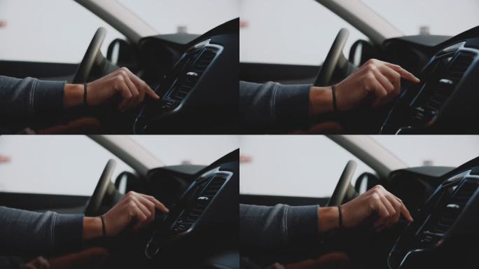 近距离男子的手滚动触摸屏仪表盘在汽车