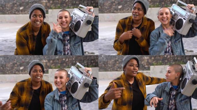 年轻的多种族女性街头音乐家在城市里说唱和跳舞-秃顶的女孩拿着老式的boombox