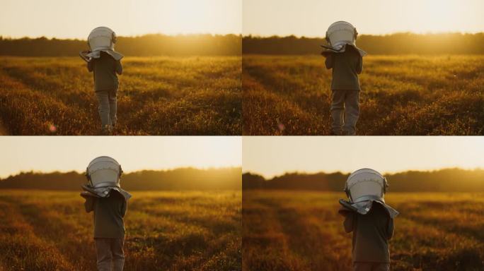快乐的童年，梦想着太空旅行和其他星球，小宇航员男孩在草地上散步