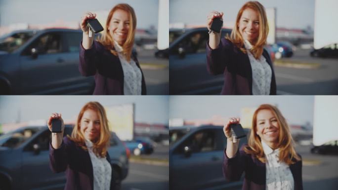 图为自信的女汽车销售员在停车场拿着车钥匙