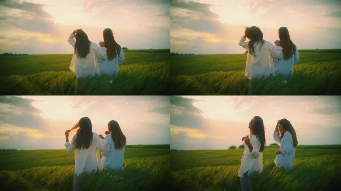 夕阳下，年轻的女性朋友们微笑着站在绿色的麦田里