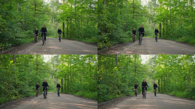 女学生群在森林里骑自行车，周末活跃的消遣，女骑手