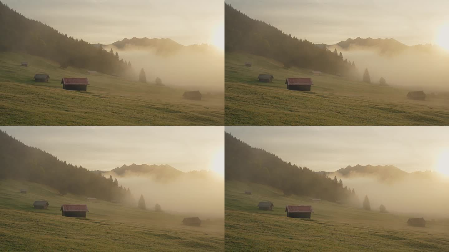 巴伐利亚阿尔卑斯山的田园风光，雾气笼罩着山谷、湖泊和小木屋