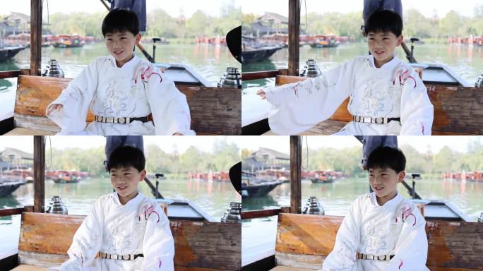 杭州西溪湿地坐摇橹船的汉服男孩