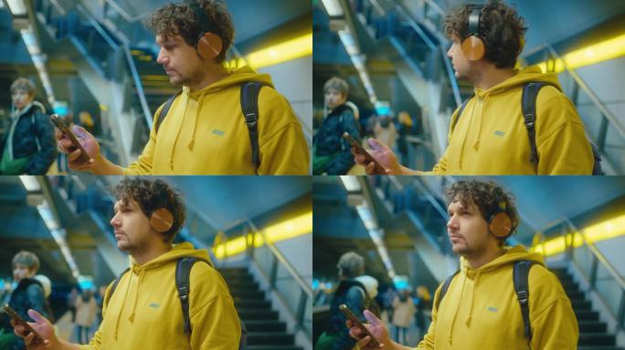 戴耳机的男子在地铁里使用手机和振动