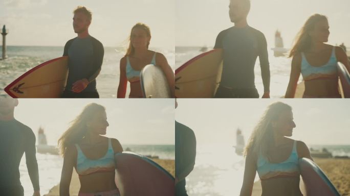 一对冲浪夫妇拿着冲浪板在阳光明媚的海滩上散步