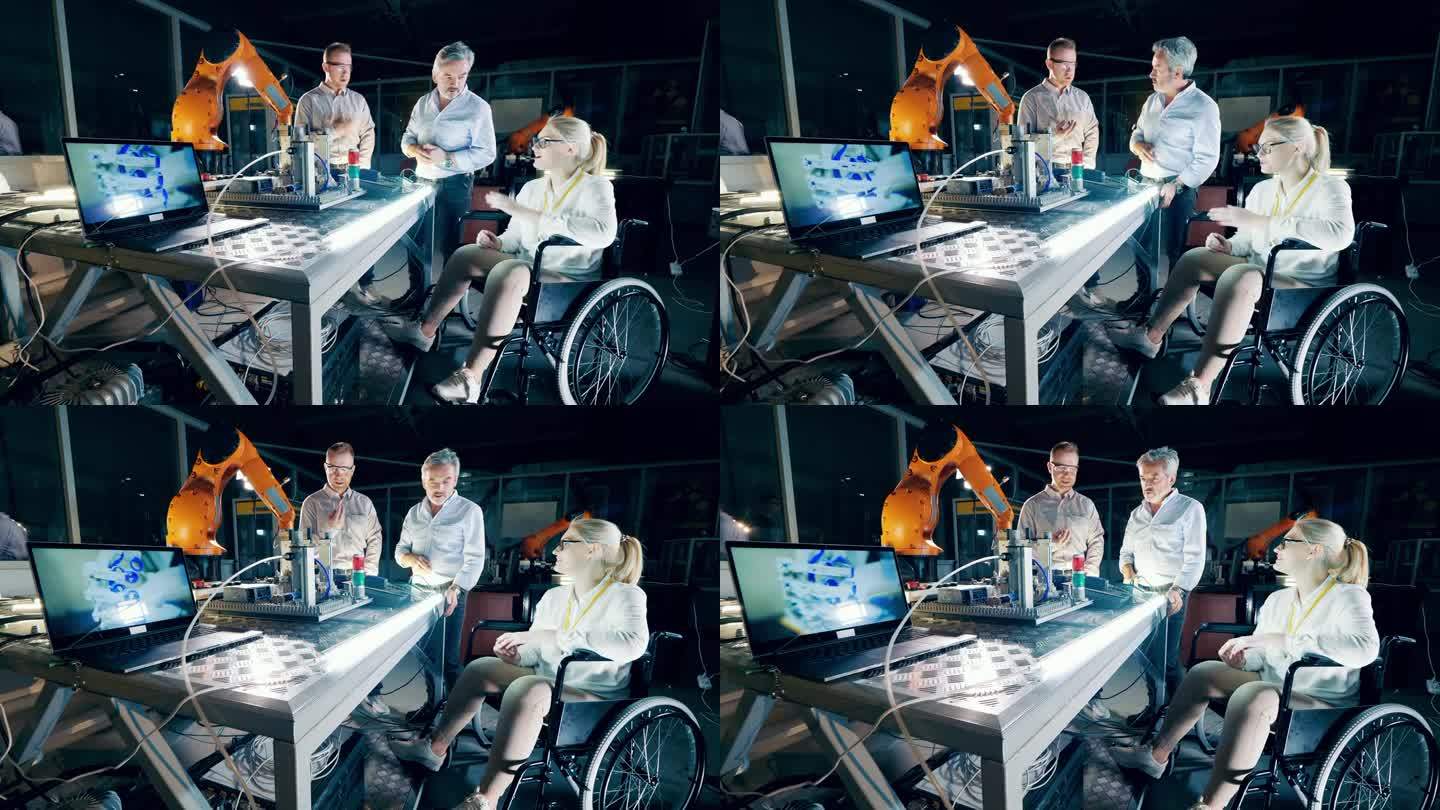 工厂的工程师们在现代化的设施里谈话，一个坐在轮椅上