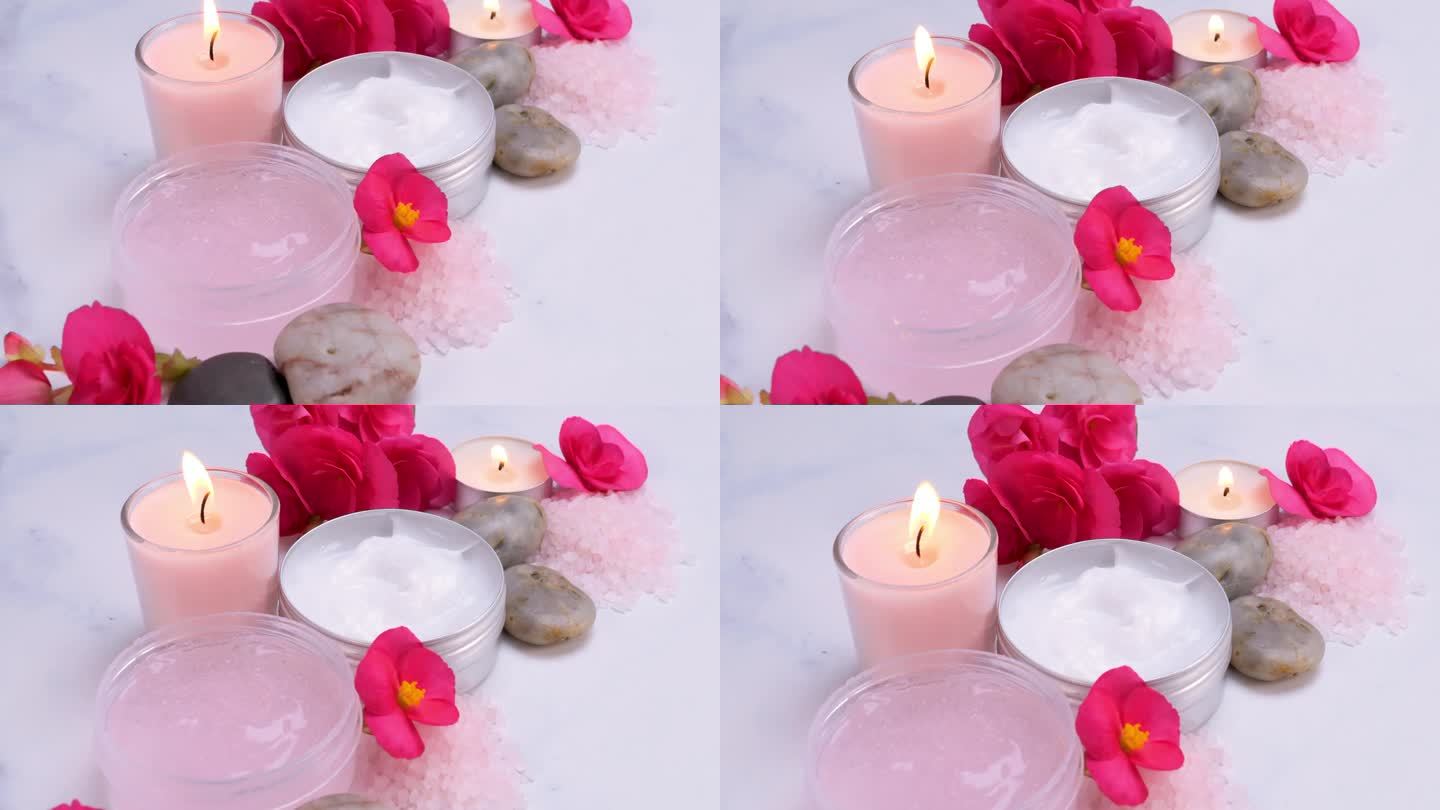 水疗概念-身体乳液，沐浴盐，鲜花和蜡烛在白色的桌子上