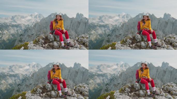 登山后，女子在山顶使用智能手机
