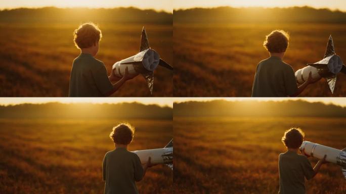 男孩梦想着太空旅行和发现，在草地上玩手工火箭