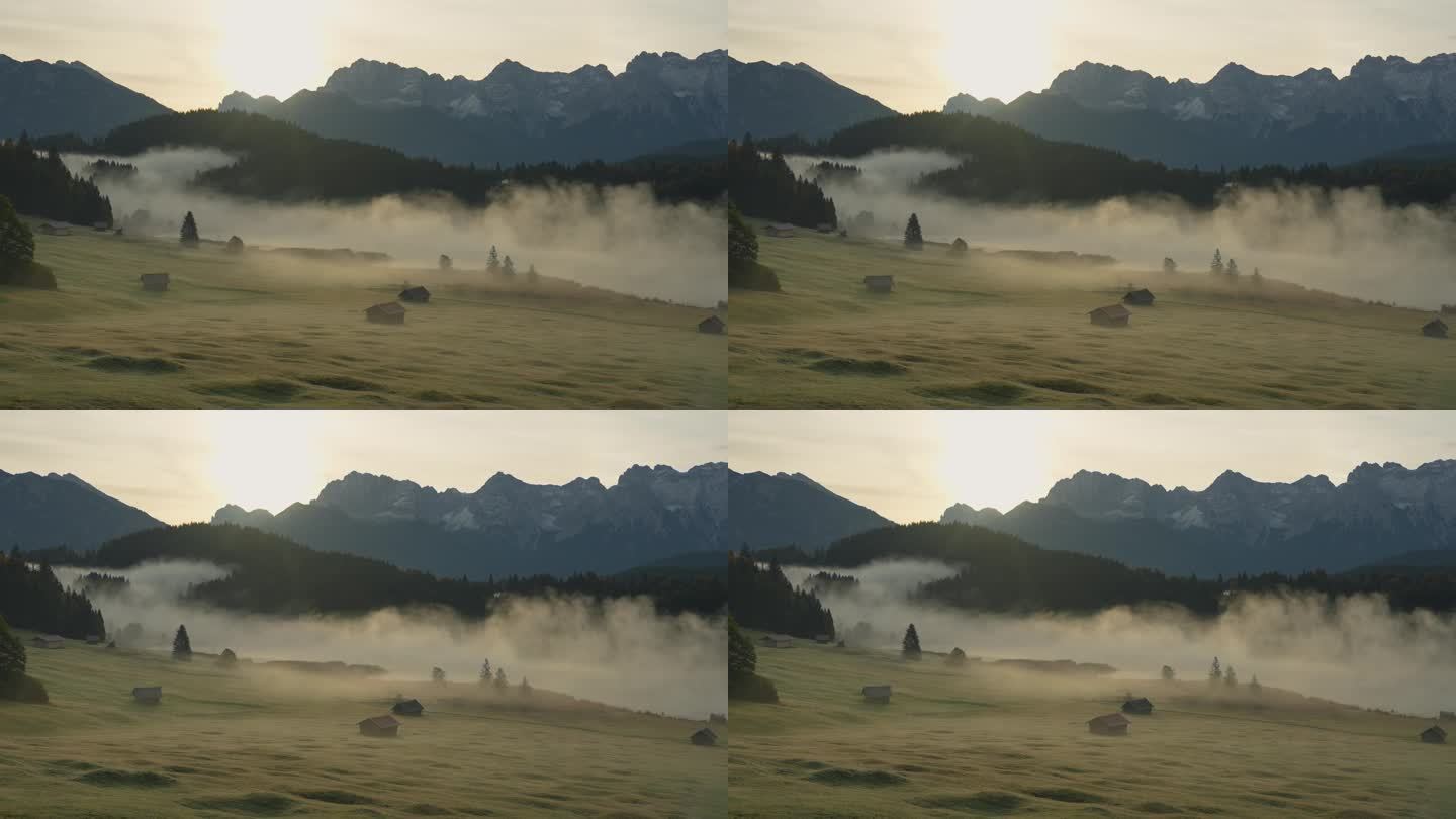 巴伐利亚阿尔卑斯山的田园风光，雾气笼罩着山谷、湖泊和小木屋