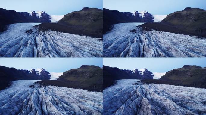 航拍:冰川蜿蜒的路径上有深深的裂缝和锯齿状的冰层，这是气候变化对这个自然奇观不断移动和转变的影响的证