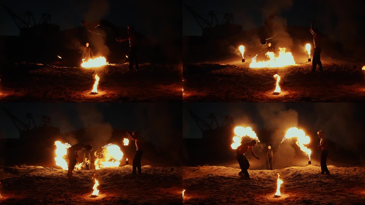 夜间户外火焰表演，熟练的杂技演员在沙滩上跳跃和表演空翻，慢动作