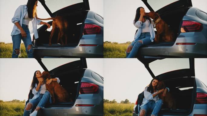 日落时分，女子坐在汽车后备箱里训练狗
