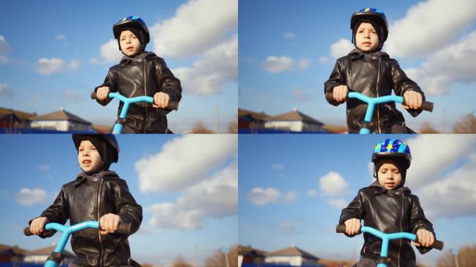 可爱的小男孩戴着安全帽，在阳光明媚的日子里学习骑第一辆平衡自行车。快乐的男孩骑着自行车，在日落时分在