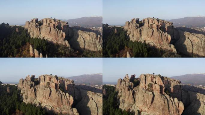 缓慢拉入的空中无人机拍摄的自然岩层，在保加利亚维丁省的巴尔干山脉的前面，有一个堡垒。