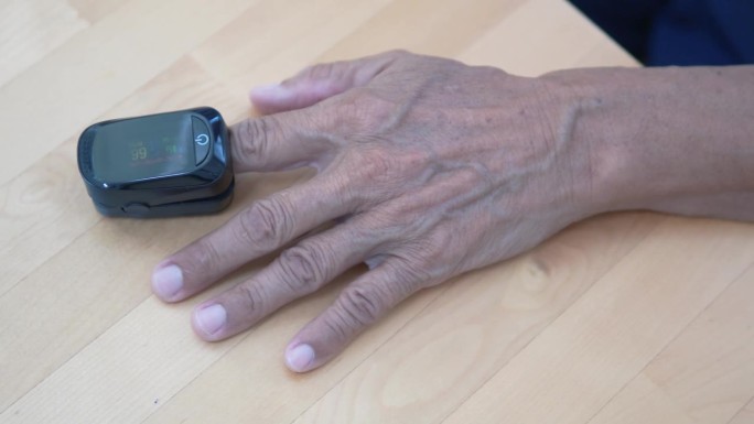 一位老人用指尖血氧计检查哮喘症状。