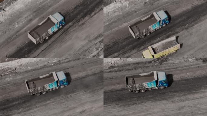 煤矿开采-载满泥浆的自卸卡车在矿区行驶的鸟瞰图。