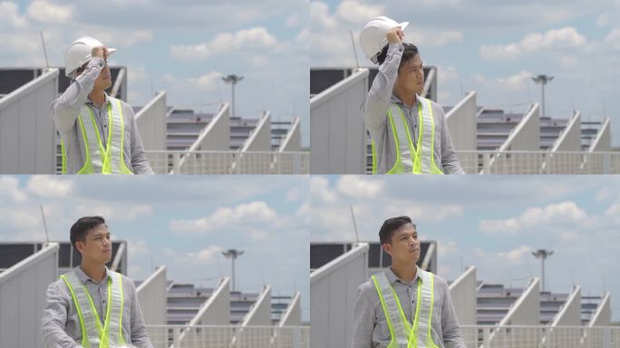 亚洲男性专业工程师工作时摘掉安全安全帽休息。