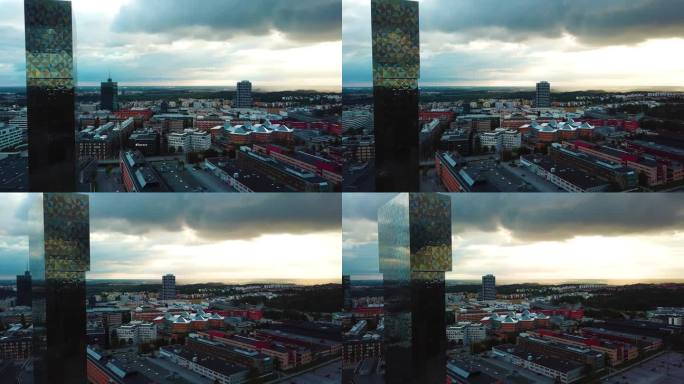 这张照片描绘了Kista上空令人惊叹的日落，旋转视图捕捉到高层建筑的反射，增强了建筑景观的美感。