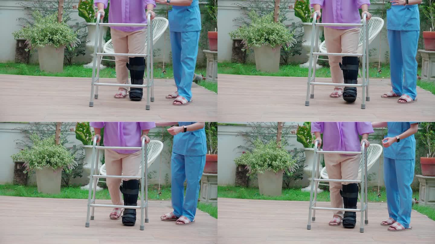 近距离腿部护理妇女帮助和支持老年妇女在家中花园用助行器进行康复和物理治疗，护士护理老年人同时进行物理