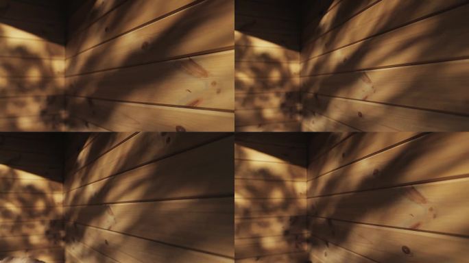 树叶在木屋木墙上的影子，多利拍摄的木质纹理，背景。