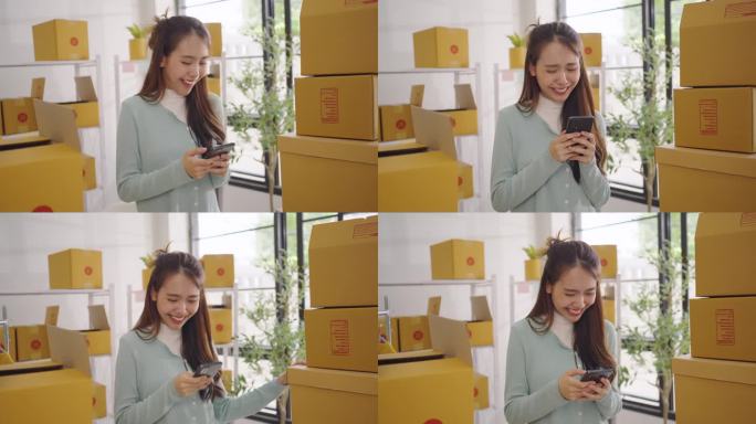 图为，亚洲中小企业零售商店的女店主正在用手机接收订单，对超额完成销售目标表示高兴