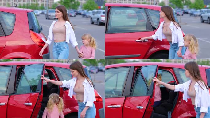 微笑的女人牵着小女孩的手在停车场向汽车走去。孩子坐在后座的汽车座椅上。家庭、交通、出行、安全、亲子观