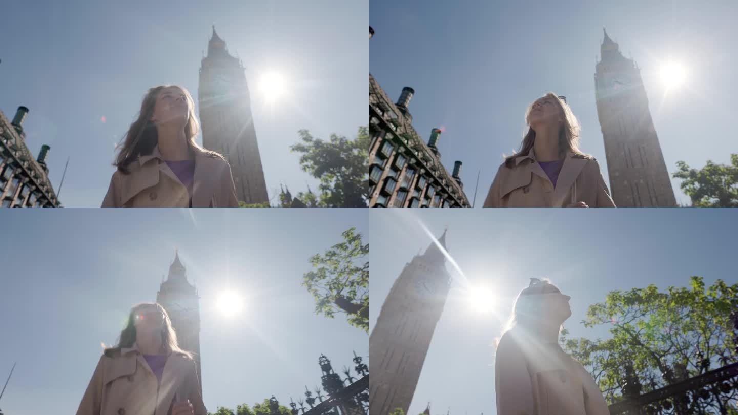 一个十几岁的女孩走在英国伦敦的大本钟旁