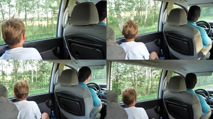 男孩从开着的车窗往外看。一家人在度假时用曼尼什语周游全国。夏天的时候，这家人会开着他们的小货车旅行。