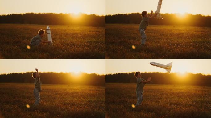 暑假小男孩在田野里玩玩具火箭，把太空船抛向空中