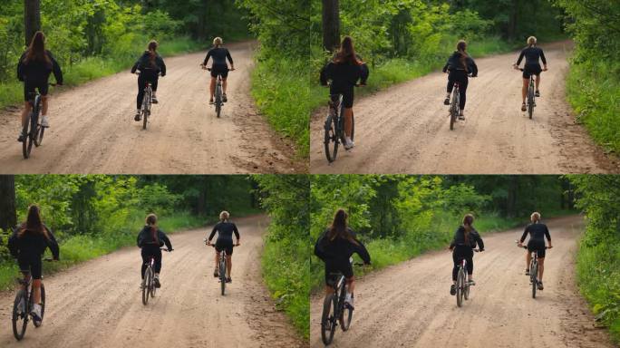 十几岁的女孩骑自行车在森林，后视图，以下镜头，慢动作，运动和积极的生活方式