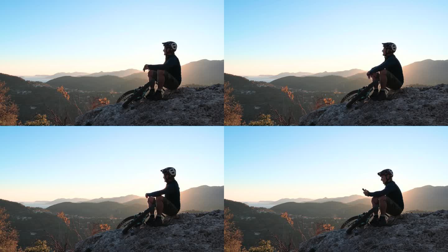 成熟的男子骑自行车探索高山山腰，秋天