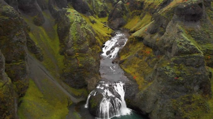 冰岛，Stjornarfoss瀑布在长满苔藓的岩石峡谷中湍急。