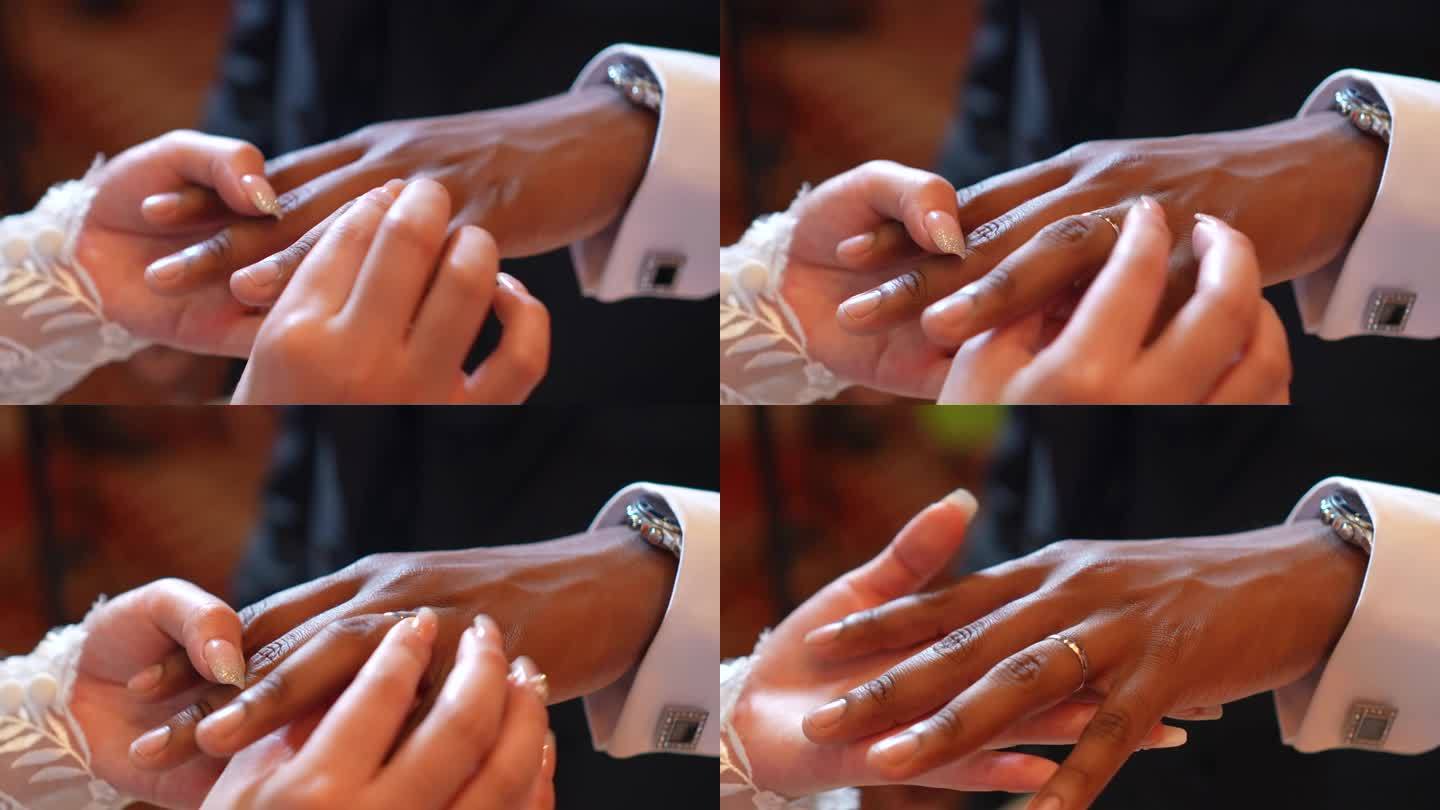 新娘在婚礼上给新郎戴上结婚戒指。婚礼的细节。