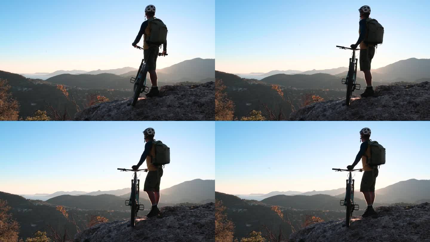 成熟的男子骑自行车探索高山山腰，秋天