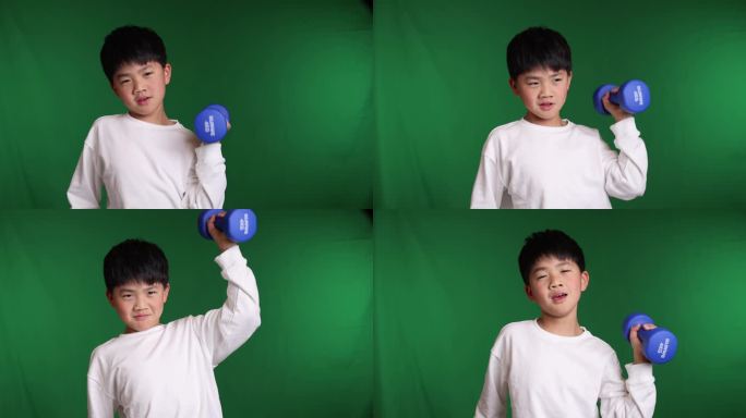 帅气的中国小男孩在举哑铃锻炼身体