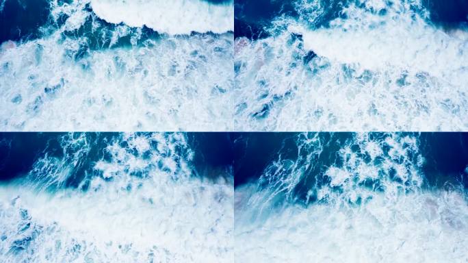 俯视图大浪美丽的纹理大力量深色海浪与白色洗涤。航拍俯视图在一个暴风雨的日子里惊人的海潮镜头。无人机在