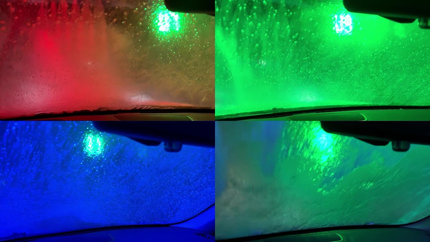 自动洗车。机器人洗车。水柱穿过挡风玻璃。多色色彩