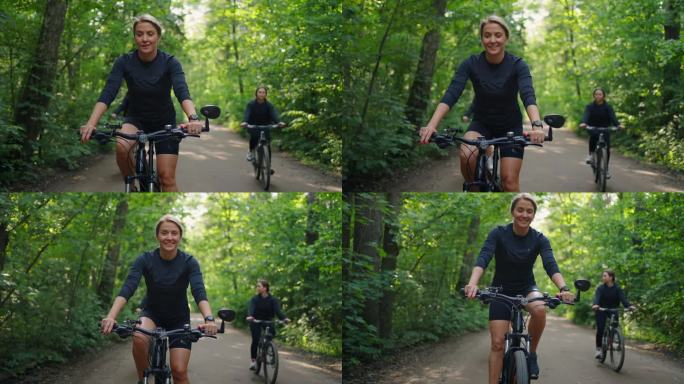 夏天在森林里骑自行车的快乐运动女人的肖像，周末的运动和娱乐