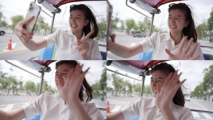 年轻的亚洲女子在泰国曼谷的嘟嘟车上微笑并直播:慢动作
