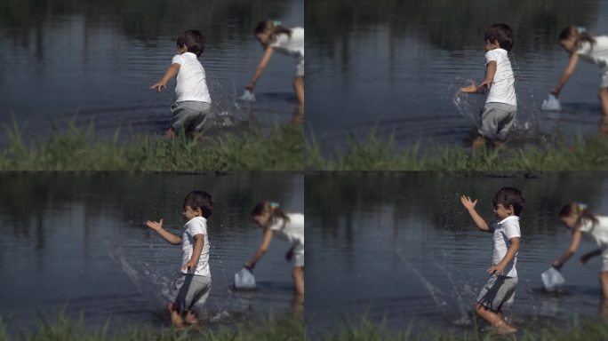 孩子手溅湖水在超慢动作。小男孩在湖边以800帧/秒的速度玩耍，与大自然亲密接触